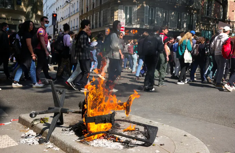 A fire of burning trash is seen during the traditional May Day labour union march in Paris, France, May 1, 2022